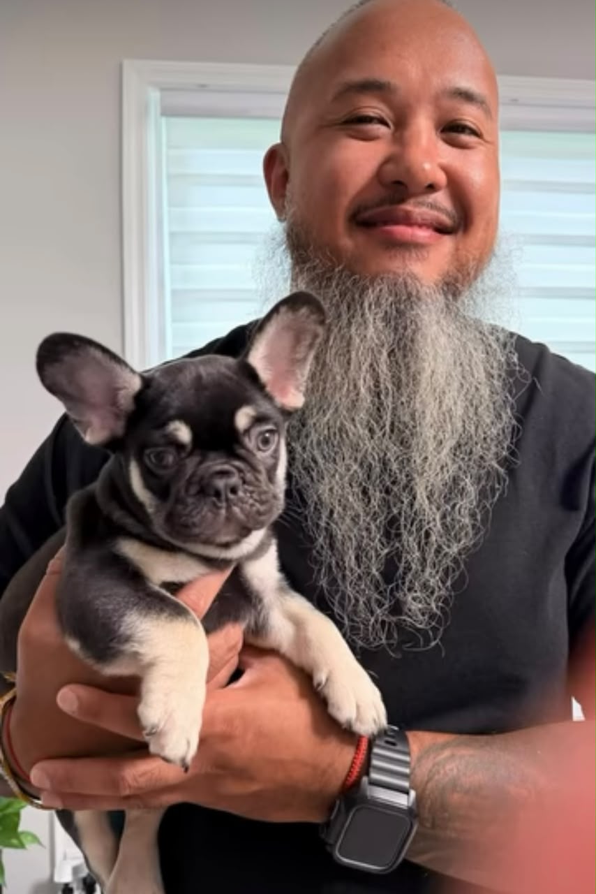Happy FrenchieAura family holding their French Bulldog puppy